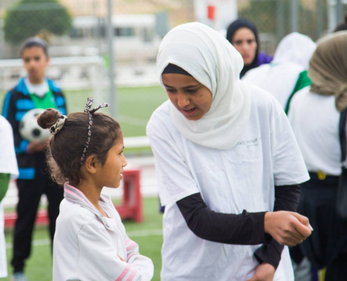 Trainers give instructions on football, girls football, Jordan