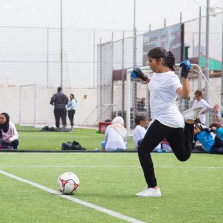 Preparing for a big shot: girls playing soccer in Jordan