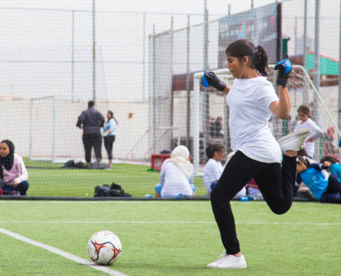 Preparing for a big shot: girls playing soccer in Jordan
